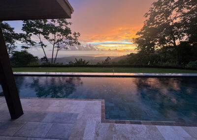 A view of the sun rising over the ocean from the pool at Villa Ballena.