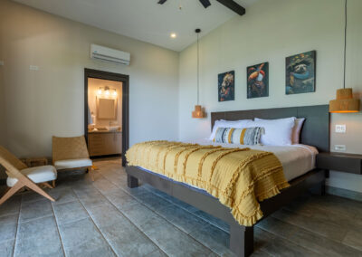 The Selva (Jungle) Suite featuring a king size bed and a small sitting area in the corner.