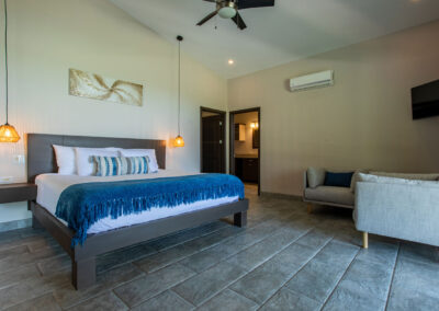 The Catarata (Waterfall) Suite of Villa Ballena features a king size bed, ensuite bathroom, small sitting area and a tv.