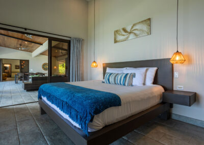 The Catarata Suite opening to the outdoor covered living space with furniture, dining area, and full kitchen.