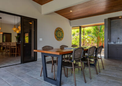 A dining table that can seat six people under the covered outdoor patio.